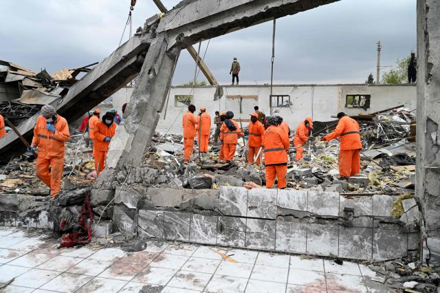 Afghan municipality workers clear debris from the site after Pakistani airstrikes hit the Omid Addiction Treatment Hospital in Kabul, on March 17, 2026. The Afghan government on March 17 said that about 400 people were killed in a Pakistani airstrike on a drug rehabilitation centre in the capital, Kabul, in the deadliest attack in the recent violence between the two neighbours. (Photo by Wakil KOHSAR / AFP)