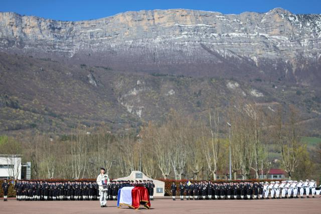 The coffin of Chief Warrant Officer Arnaud Frion who was killed in a drone attack in Erbil on March 12, 2026, lays on the ground during a national tribute ceremony at the 7th Alpine Chasseurs Battalion in Varces, southeastern France on March 17, 2026. Arnaud Frion was killed and six other French soldiers were wounded on March 12, 2026 evening in a drone attack in the Erbil region of Iraqi Kurdistan, French authorities announced, lamenting the first death within the French army in the context of the war in the Middle East. (Photo by Alex MARTIN / AFP)