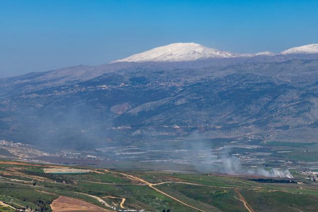 Smoke rises after an impact in southern Lebanon on the border with Israel as seen from the Upper Galilee in northern Israel on March 17, 2026. The Lebanese military said on March 17, that an Israeli strike on a car and a motorcycle in southern Lebanon killed one of its soldiers and wounded four others. Israel has stepped up strikes and deployed ground troops to its northern neighbour since March 2, when Lebanon was dragged into the wider war in the Middle East after Tehran ally Hezbollah attacked Israel with rockets in retaliation for the killing of Iranian supreme leader. (Photo by Odd ANDERSEN / AFP) / 