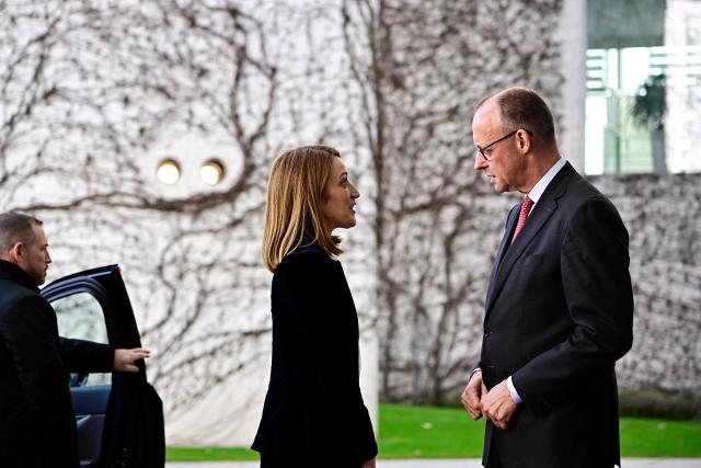 German Chancellor Friedrich Merz (R) welcomes European Parliament President Roberta Metsola upon arrival at the Chancellery in Berlin, on March 17, 2026. (Photo by Tobias SCHWARZ / AFP)