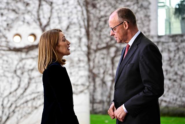 German Chancellor Friedrich Merz (R) welcomes European Parliament President Roberta Metsola upon arrival at the Chancellery in Berlin, on March 17, 2026. (Photo by Tobias SCHWARZ / AFP)