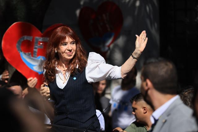 Former Argentine president (2007–2015) Cristina Kirchner waves as she arrives at her home in Buenos Aires after being questioned at the Comodoro Py courthouse on March 17, 2026. Kirchner, who is under house arrest, appeared before the court for questioning in the “Notebooks of Corruption” case. (Photo by Emiliano Lasalvia / AFP)
