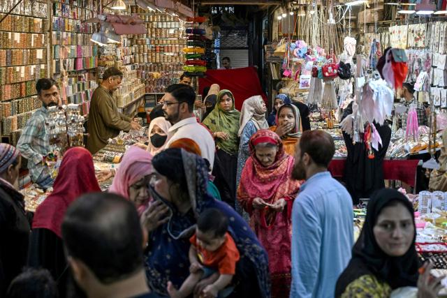 Muslims shop at a market for the Eid al-Fitr celebrations during the last week of the Islamic holy fasting month of Ramadan in Karachi on March 17, 2026. (Photo by Rizwan TABASSUM / AFP)