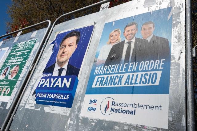This photograph shows electoral posters of far-right party Rassemblement National (RN)'s candidate for mayor of Marseille, Franck Allisio and Marseille's incumbent mayor and candidate for re-election Benoit Payan, in Marseille, south-eastern France on March 17, 2026. With just a few hours to go before the deadline for submitting candidate lists for the second round of the local elections, the situation in Marseille was becoming clearer following the withdrawal of left-wing La France Insoumise (LFI) candidate Sebastien Delogu, which is likely to pave the way for Benoît Payans re-election against the Rassemblement National. (Photo by Elodie CLEMENT / AFP)