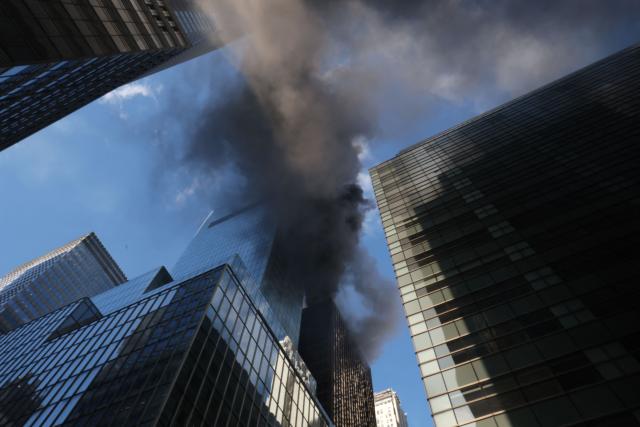 Fire and heavy smoke are seen at a high-rise building in Midtown Manhattan near the St. Patrick’s Day Parade route in New York City on March 17, 2026. (Photo by TIMOTHY A.CLARY / AFP)