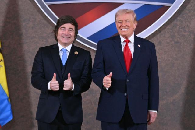 (FILES) US President Donald Trump and Argentina's President Javier Milei (L) pose for a photo at the beginning of the "Shield of the Americas" Summit at Trump National Doral in Miami, Florida, March 7, 2026. Argentina formally withdrew from the World Health Organization on March 17, 2026, the foreign minister said, following in the path of the United States which took the same step earlier this year. The government of President Javier Milei, a close ally of President Donald Trump, had announced its intention to leave the UN health body a year ago, criticizing the WHO's handling of the Covid-19 pandemic. (Photo by Saul LOEB / AFP)