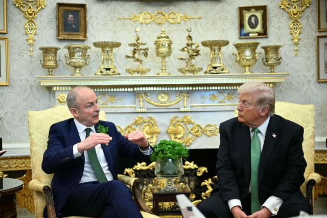 US President Donald Trump listens to Irish Prime Minster Micheal Martin during their bilateral meeting in the Oval Office of the White House in Washington, DC, on March 17, 2026. The Irish prime minister arrived in the United States March 13 for an annual St Patrick's Day trip under pressure to talk tough to US President Donald Trump amid the Iran war. (Photo by Jim WATSON / AFP)