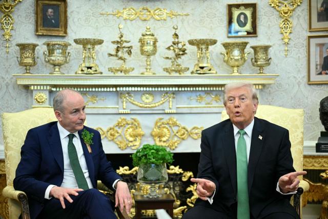 Irish Prime Minster Micheal Martin  listens to US President Donald Trump during their bilateral meeting in the Oval Office of the White House in Washington, DC, on March 17, 2026. The Irish prime minister arrived in the United States March 13 for an annual St Patrick's Day trip under pressure to talk tough to US President Donald Trump amid the Iran war. (Photo by Jim WATSON / AFP)