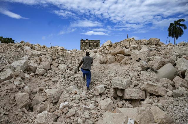 A man looks for materials from the rubble of the National School of Design in Havana on March 16, 2026. Cuba scrambled on March 17, 2026, to restore power after a nationwide blackout that hit the communist-run island just as US President Donald Trump proclaimed he will "take" it over. (Photo by YAMIL LAGE / AFP)