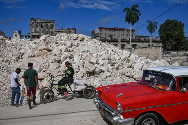 People look for materials from the rubble of the National School of Design in Havana on March 16, 2026. Cuba scrambled on March 17, 2026, to restore power after a nationwide blackout that hit the communist-run island just as US President Donald Trump proclaimed he will "take" it over. (Photo by YAMIL LAGE / AFP)