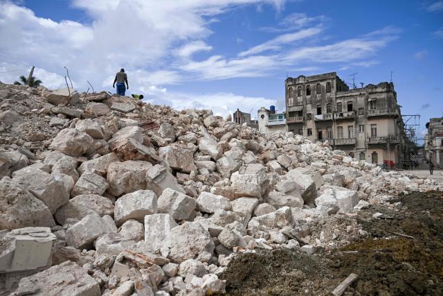A man looks for materials from the rubble of the National School of Design in Havana on March 16, 2026. Cuba scrambled on March 17, 2026, to restore power after a nationwide blackout that hit the communist-run island just as US President Donald Trump proclaimed he will "take" it over. (Photo by YAMIL LAGE / AFP)