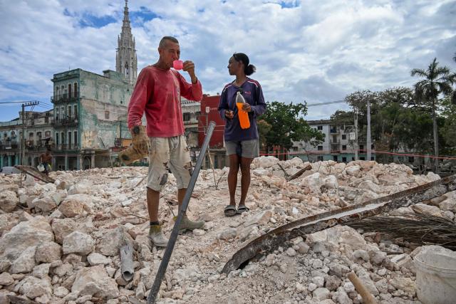 A man rests while collecting materials to sell from the rubble of the National School of Design in Havana on March 16, 2026. Cuba scrambled on March 17, 2026, to restore power after a nationwide blackout that hit the communist-run island just as US President Donald Trump proclaimed he will "take" it over. (Photo by YAMIL LAGE / AFP)