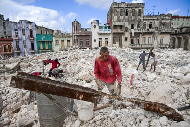 A man collects materials to sell from the rubble of the National School of Design in Havana on March 16, 2026. Cuba scrambled on March 17, 2026, to restore power after a nationwide blackout that hit the communist-run island just as US President Donald Trump proclaimed he will "take" it over. (Photo by YAMIL LAGE / AFP)