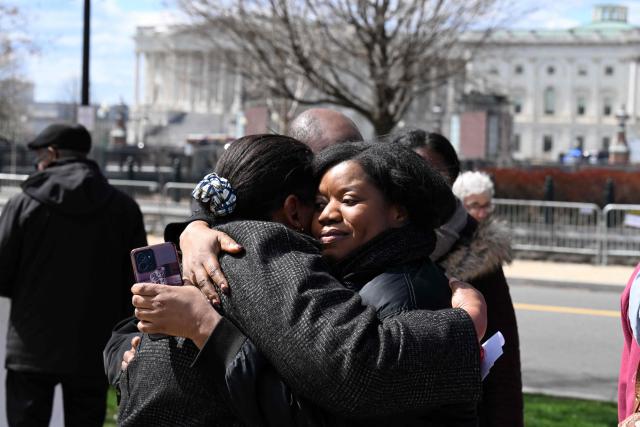 Two Haitian human rights activists embrace outside the US Supreme Court in Washington, DC, on March 17, 2026. The US Supreme Court agreed on March 16 to consider the Trump administration's bid to strip Haitians and Syrians of temporary deportation protections. The Department of Homeland Security (DHS) has announced plans to end so-called Temporary Protected Status (TPS) for some 350,000 Haitians and 6,000 Syrians. (Photo by ROBERTO SCHMIDT / AFP)
