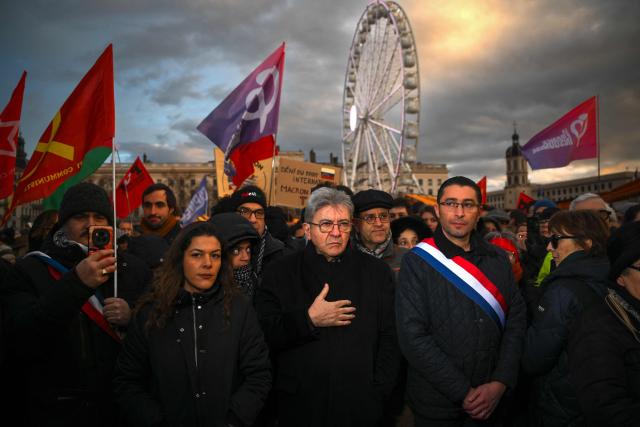 (FILES) Leader of French left-wing La France Insoumise (LFI) party Jean-Luc Melenchon (C) with deputy Anaпs Belouassa-Cherifi (2nd-L) and Idir Boumertit (2nd-R), takes part in a demonstration at Place Bellecour in Lyon, central-eastern France on January 10, 2026, to support Venezuelan people, one week after the US raids in Caracas and the detention of Venezuelan deposed President Nicolas Maduro. In the first round, Michиle Picard came out only 269 votes ahead of her rival from La France insoumise — and former deputy mayor — Idir Boumertit, with 28.32% of the vote compared with the MP’s 25.95%. Since then, she has formed an alliance with another left?wing candidate, Mokrane Kessi, who received 6.05% of the vote — and hopes to contradict the national trend of declining municipal communism. (Photo by OLIVIER CHASSIGNOLE / AFP)