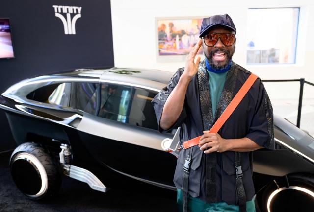 US rapper Will.i.am speaks in front of Trinity, an electric, AI-powered three-wheeled vehicle, during an interview at NVidia's annual GTC developers conference in San Jose, California, on March 17, 2026. (Photo by JOSH EDELSON / AFP)