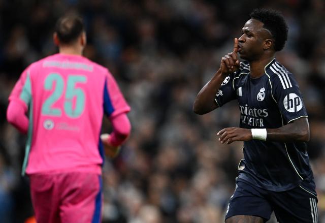 Real Madrid's Brazilian forward #07 Vinicius Junior celebrates scoring the opening goal during the UEFA Champions League, round of 16 second leg football match between Manchester City and Real Madrid at the Etihad Stadium in Manchester, north west England, on March 17, 2026. (Photo by Paul ELLIS / AFP)