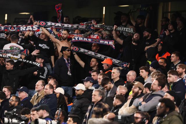 Paris Saint-Germain's supporters (up) cheer next to Chelsea's supporters during the UEFA Champions League round of 16 second leg football match between Chelsea FC and Paris Saint-Germain (PSG) at Stamford Bridge, west London on March 17, 2026. (Photo by FRANCK FIFE / AFP)