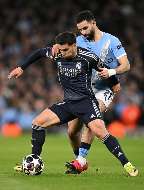 Manchester City's Algerian defender #21 Rayan Ait-Nouri and Real Madrid's Moroccan forward #21 Brahim Diaz vie for the ball during the UEFA Champions League, round of 16 second leg football match between Manchester City and Real Madrid at the Etihad Stadium in Manchester, north west England, on March 17, 2026. (Photo by Oli SCARFF / AFP)