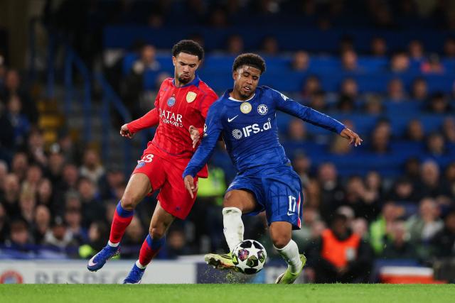 Paris Saint-Germain's French midfielder #33 Warren Zaire-Emery fights for the ball with Chelsea's Brazilian midfielder #17 Andrey Santos during the UEFA Champions League round of 16 second leg football match between Chelsea FC and Paris Saint-Germain (PSG) at Stamford Bridge, west London on March 17, 2026. (Photo by Adrian Dennis / AFP)