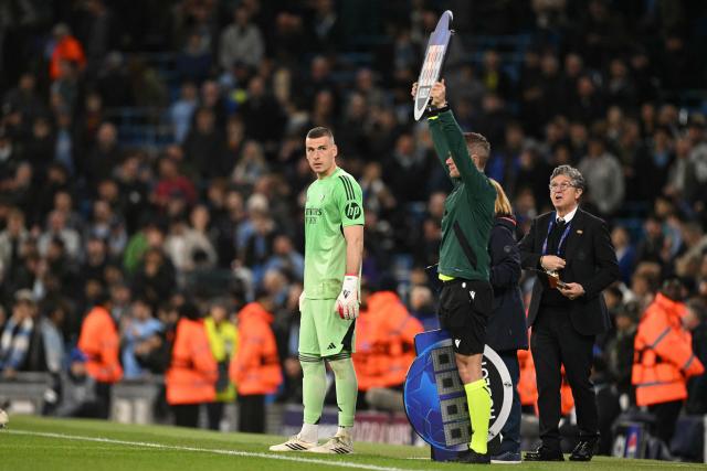 Real Madrid's Ukrainian goalkeeper #13 Andriy Lunin waits to come on as a substitute during the UEFA Champions League, round of 16 second leg football match between Manchester City and Real Madrid at the Etihad Stadium in Manchester, north west England, on March 17, 2026. (Photo by Oli SCARFF / AFP)