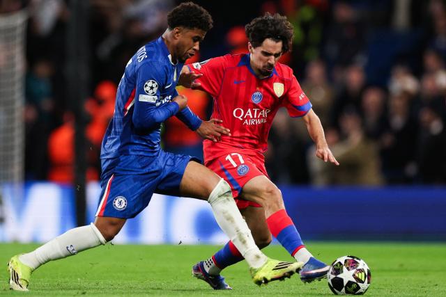 Chelsea's Brazilian midfielder #17 Andrey Santos (L) fights for the ball with Paris Saint-Germain's Portuguese midfielder #17 Vitinha during the UEFA Champions League round of 16 second leg football match between Chelsea FC and Paris Saint-Germain (PSG) at Stamford Bridge, west London on March 17, 2026. (Photo by Adrian Dennis / AFP)