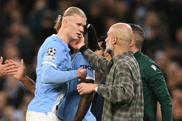 Manchester City's Spanish manager Pep Guardiola (R) speaks with Manchester City's Norwegian striker #09 Erling Haaland (L) as he is substituted during the UEFA Champions League, round of 16 second leg football match between Manchester City and Real Madrid at the Etihad Stadium in Manchester, north west England, on March 17, 2026. (Photo by Oli SCARFF / AFP)