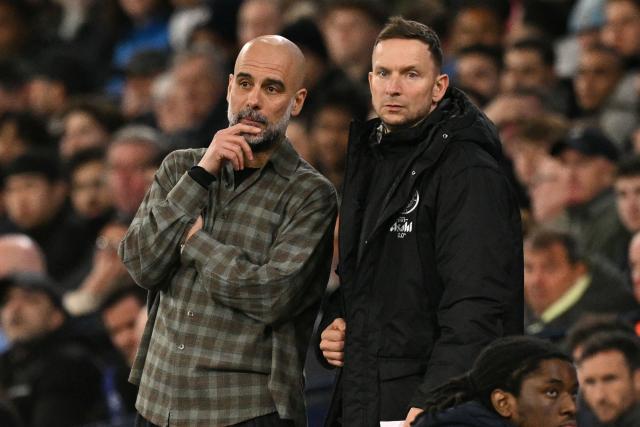 Manchester City's Spanish manager Pep Guardiola (L) chats with Manchester City's Dutch assistant coach Pepijn Lijnders (R) on the touchline during the UEFA Champions League, round of 16 second leg football match between Manchester City and Real Madrid at the Etihad Stadium in Manchester, north west England, on March 17, 2026. (Photo by Oli SCARFF / AFP)