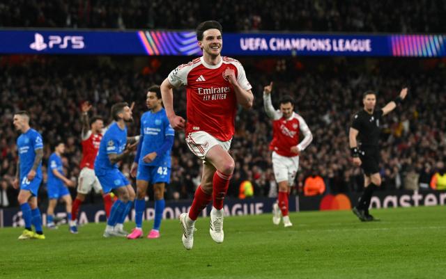 Arsenal's English midfielder #41 Declan Rice celebrates scoring the team's second goal during the UEFA Champions League, last 16 second leg football match between Arsenal and Bayer Leverkusen at the Emirates Stadium in north London on March 17, 2026. (Photo by Glyn KIRK / AFP)