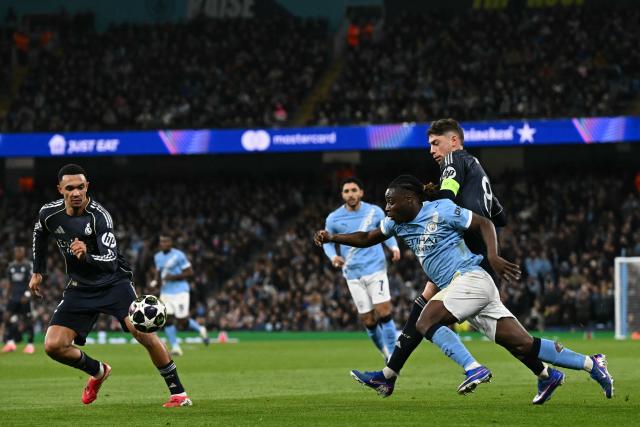 Manchester City's Belgian midfielder #11 Jeremy Doku (C) vies with Real Madrid's English defender #12 Trent Alexander-Arnold (L) and Real Madrid's Uruguayan midfielder #08 Federico Valverde (R) during the UEFA Champions League, round of 16 second leg football match between Manchester City and Real Madrid at the Etihad Stadium in Manchester, north west England, on March 17, 2026. (Photo by Paul ELLIS / AFP)