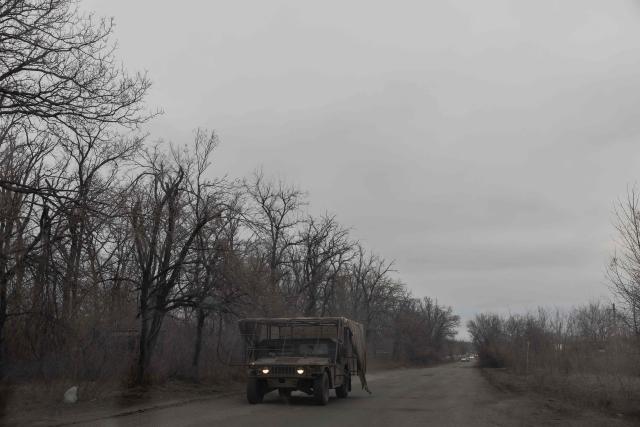 A US-made Humvee driven by a Ukrainian serviceman equipped with additional anti-drone protection drives on a road in the Kharkiv region on March 17, 2026, amid the Russian invasion of Ukraine. (Photo by Roman PILIPEY / AFP)