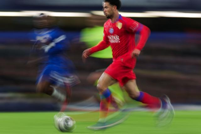 This slow shutter photograph shows Paris Saint-Germain's French midfielder #33 Warren Zaire Emery running with the ball during the UEFA Champions League round of 16 second leg football match between Chelsea FC and Paris Saint-Germain (PSG) at Stamford Bridge, west London on March 17, 2026. (Photo by Adrian Dennis / AFP)