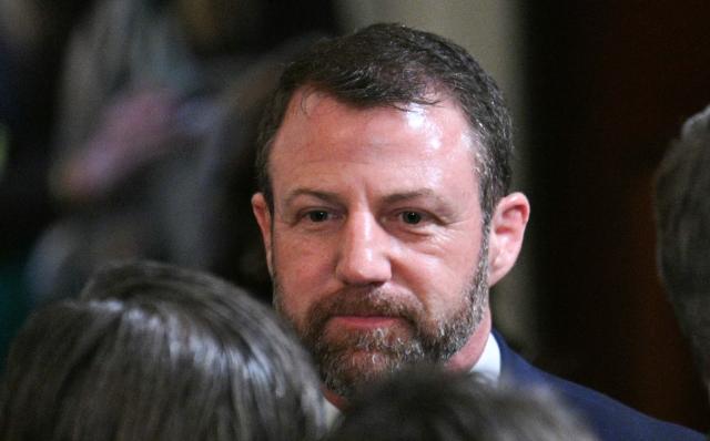 US Senator Markwayne Mullin, Republican from Oklahoma, tapped by US President Donald Trump to replace US Homeland Security Secretary Kristi Noem attends an event with Irish Prime Minster Micheal Martin and US President Donald Trump in the East Room of the White House in Washington, DC on March 17, 2026. (Photo by Jim WATSON / AFP)