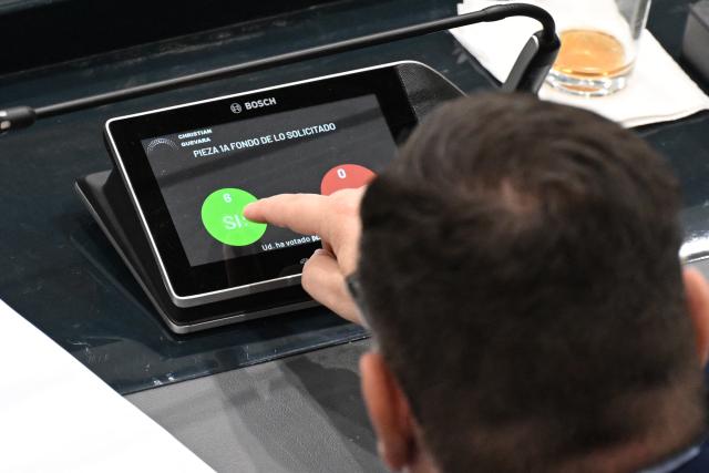 Christian Guevara, deputy from the Nuevas Ideas party, votes on the constitutional reform to approve life imprisonment in San Salvador on March 17, 2026. The government of Salvadoran President Nayib Bukele proposed on March 17, in the Congress it controls, a constitutional reform that establishes life imprisonment for ‘murderers, rapists, and terrorists,’ after accusing NGOs of protecting gang members. (Photo by Marvin RECINOS / AFP)