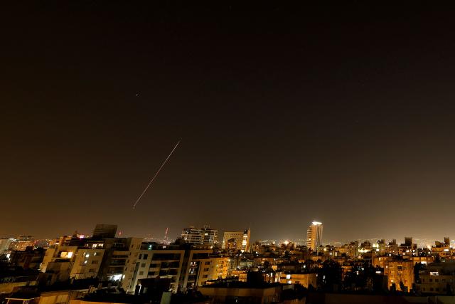 Rocket trails are seen in the sky amid a fresh barrage of Iranian missile attacks above the Israeli coastal city of Netanya on March 18, 2026. (Photo by JACK GUEZ / AFP) / 