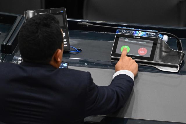 Saul Mancia, deputy from the Nuevas Ideas party, votes on the constitutional reform to approve life imprisonment in San Salvador on March 17, 2026. The government of Salvadoran President Nayib Bukele proposed on March 17, in the Congress it controls, a constitutional reform that establishes life imprisonment for ‘murderers, rapists, and terrorists,’ after accusing NGOs of protecting gang members. (Photo by Marvin RECINOS / AFP)