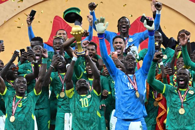 (FILES) Senegal's forward #10 Sadio Mane holds up the trophy as he celebrates with his teammates after winning the Africa Cup of Nations (CAN) final football match against Morocco at the Prince Moulay Abdellah Stadium in Rabat on January 18, 2026. Senegal was stripped of its Africa Cup of Nations title by the Confederation of African Football (CAF) over its players' walk-off during the final, with Morocco declared champions, CAF announced on March 17, 2026. CAF confirmed the appeal by the Royal Moroccan Football Federation was upheld, overturning the earlier CAF Disciplinary Board decision that had allowed Senegal to keep their victory. (Photo by SEBASTIEN BOZON / AFP)
