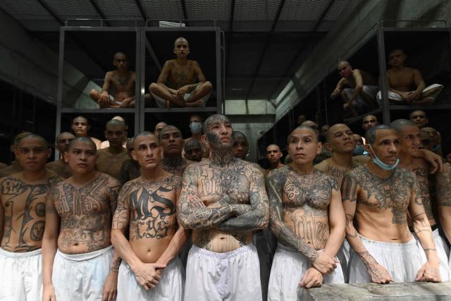 (FILES) Inmates remain in a cell at the Counter-Terrorism Confinement Centre (CECOT) mega-prison, where hundreds of members of the MS-13 and 18 Street gangs are being held, in Tecoluca, El Salvador on January 27, 2025. Salvadoran lawmakers on March 17, 2026 passed a constitutional reform proposed by iron-fisted President Nayib Bukele to allow sentences of life imprisonment for "murderers, rapists and terrorists." (Photo by Marvin RECINOS / AFP)