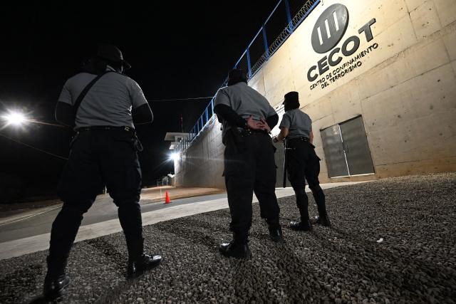 (FILES) Government prison security officers stand guard inside the newly inaugurated "Terrorist Confinement Centre" (CECOT), at a secluded rural area in a valley near Tecoluca, 74 km southeast of San Salvador, on February 2, 2023. Salvadoran lawmakers on March 17, 2026 passed a constitutional reform proposed by iron-fisted President Nayib Bukele to allow sentences of life imprisonment for "murderers, rapists and terrorists." (Photo by Marvin RECINOS / AFP)