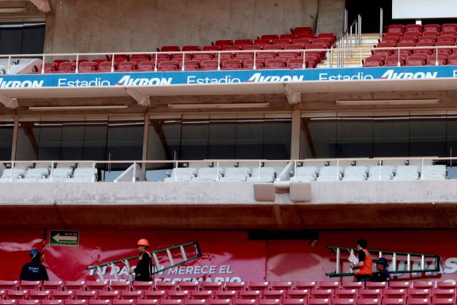 Workers carry out repairs in the main boxes of Akron Stadium, home of the Guadalajara soccer club, in Zapopan, Jalisco, Mexico, on March 17, 2026. Akron Stadium will host two World Cup playoff matches next week and will be one of Mexico’s three venues for the 2026 World Cup. (Photo by ULISES RUIZ / AFP)