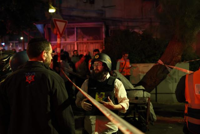 First responders inspect the damage at the site of a missile strike in Ramat Gan, in the outskirts of Tel-Aviv, Israel on March 18, 2026. (Photo by Ilia YEFIMOVICH / AFP)