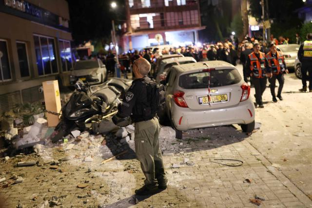 First responders inspect the damage at the site of a missile strike in Ramat Gan, in the outskirts of Tel-Aviv, Israel on March 18, 2026. (Photo by Ilia YEFIMOVICH / AFP)