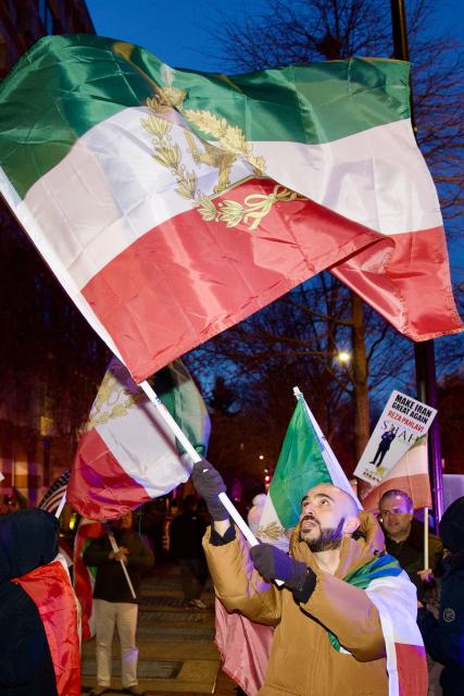 An Iranian protester waves a flag during a demonstration organized by diaspora groups calling for political change in Iran and responding to appeals by opposition figures, outside the Iranian Interests Section in Washington, DC, on March 17, 2026, US President Donald Trump said that he does not know whether Iran's new supreme leader Mojtaba Khamenei is still alive, adding that Washington was unclear whom it could negotiate with in Tehran. (Photo by Amid FARAHI / AFP)