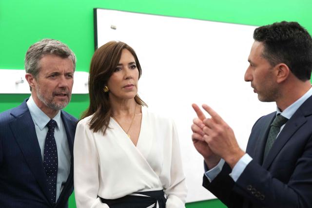 Denmark's King Frederik X (L) and Queen Mary (C) listen to Professor Enzo Porello (R), Theme Director of the Murdoch Children’s Research Institute (MCRI), during a tour of the MCRI at the Royal Children’s Hospital in Melbourne on March 18, 2026. (Photo by Asanka Ratnayake / POOL / AFP)