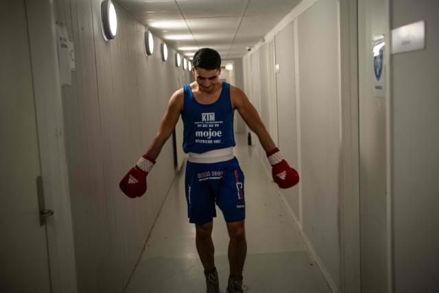 A boxer tries to psych himself up in the locker-room hallway before stepping into the ring for an international junior bout in Nuuk, on February 28, 2026. Greenland has one of the highest suicide rates in the world, especially among teenagers and young adults. Psychiatric care is uneven, and many youths must leave their families to study in Nuuk. In the capital, many turn to boxing as a way to channel their pain. (Photo by Florent VERGNES / AFP)