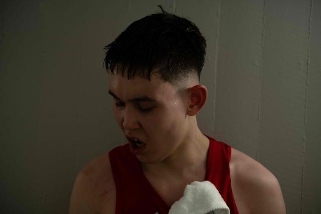 Nunu, a Greenlandic fighter, swears in the locker room after winning a boxing match in Nuuk, Greenland, on February 28, 2026. Greenland has one of the highest suicide rates in the world, especially among teenagers and young adults. Psychiatric care is uneven, and many youths must leave their families to study in Nuuk. In the capital, many turn to boxing as a way to channel their pain. (Photo by Florent VERGNES / AFP)