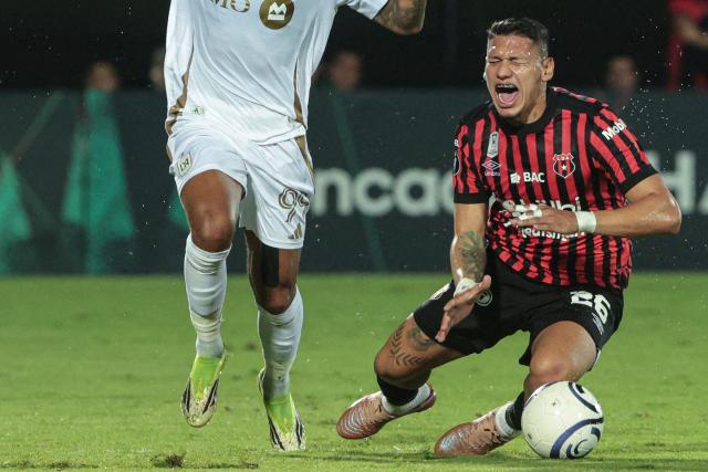 Alajuelense's defender #26 Fernando Pinar reacts in pain next to Los Angeles FC's Gabonese forward #99 Denis Bouanga during the CONCACAF Central American Cup round of 16 second leg football match between Costa Rica's Alajuelense and US' Los Angeles FC at the Alejandro Morera Soto Stadium in Alajuela, Costa Rica on March 17, 2026. (Photo by JOHN DURAN / AFP)