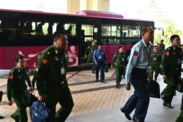 Military appointed representatives arrive to attend the Amyotha Hluttaw, Upper House of Parliament of Myanmar, in Naypyidaw on March 18, 2026. (Photo by Sai Aung MAIN / AFP)