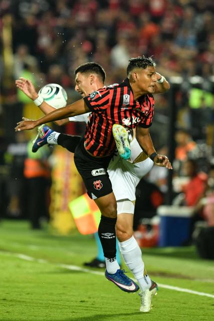 Los Angeles FC's midfielder #08 Mark Delgado and Alajuelense's midfielder #34 Creichel Perez fight for the ball during the CONCACAF Central American Cup round of 16 second leg football match between Costa Rica's Alajuelense and US' Los Angeles FC at the Alejandro Morera Soto Stadium in Alajuela, Costa Rica on March 17, 2026. (Photo by Ezequiel BECERRA / AFP)