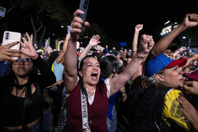 Venezuelan fans celebrate their national baseball team's victory in the final of the 2026 World Baseball Classic against the United States team, in Caracas on March 17, 2026. Venezuela, where baseball is the national sport, capped off its dream tournament by defeating the favorite, the United States, on home soil, amid tense relations between the two governments following the capture of President Nicolás Maduro by U.S. forces in January. (Photo by Juan BARRETO / AFP)